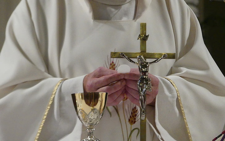 Priest Holding the Eucharist 